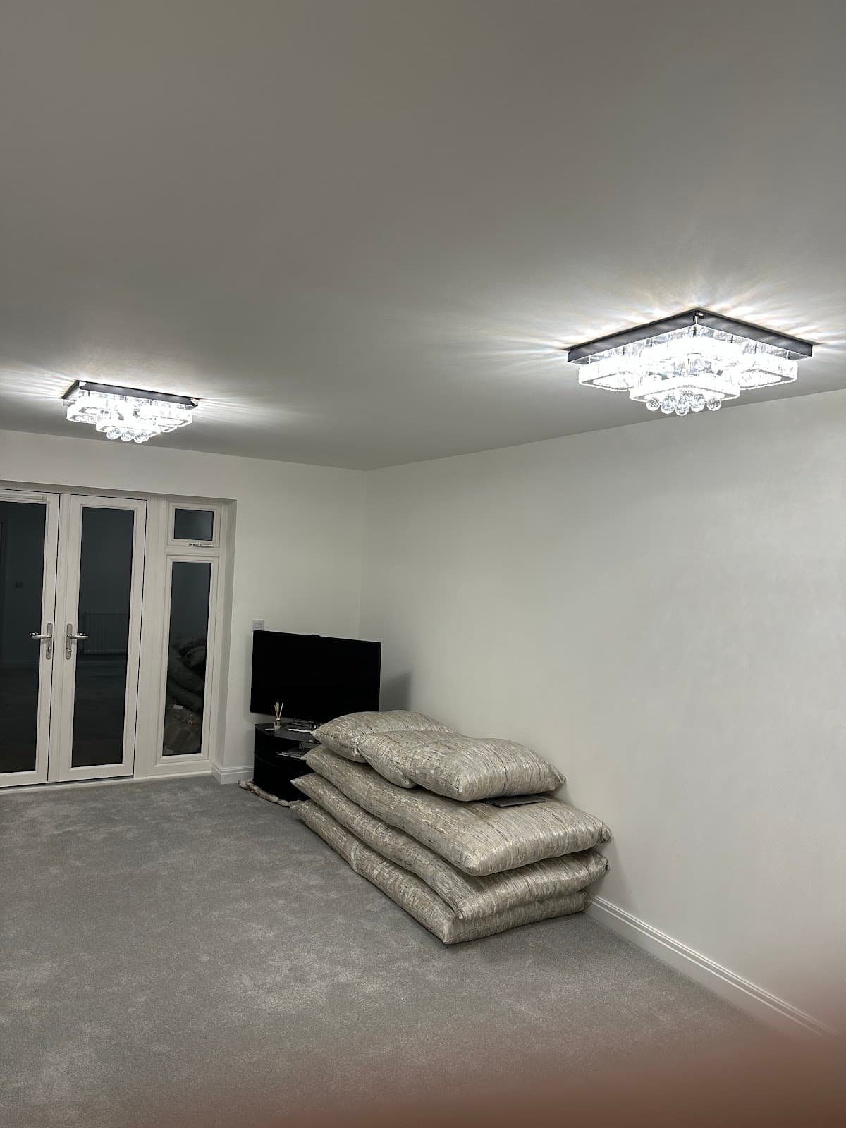 Two crystal flush ceiling lights fitted in a living room