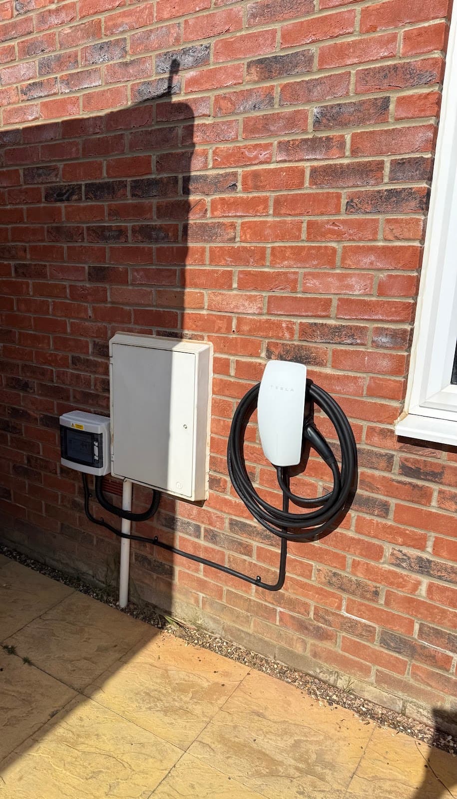 EV charger fitted to a brick wall with neatly routed cable