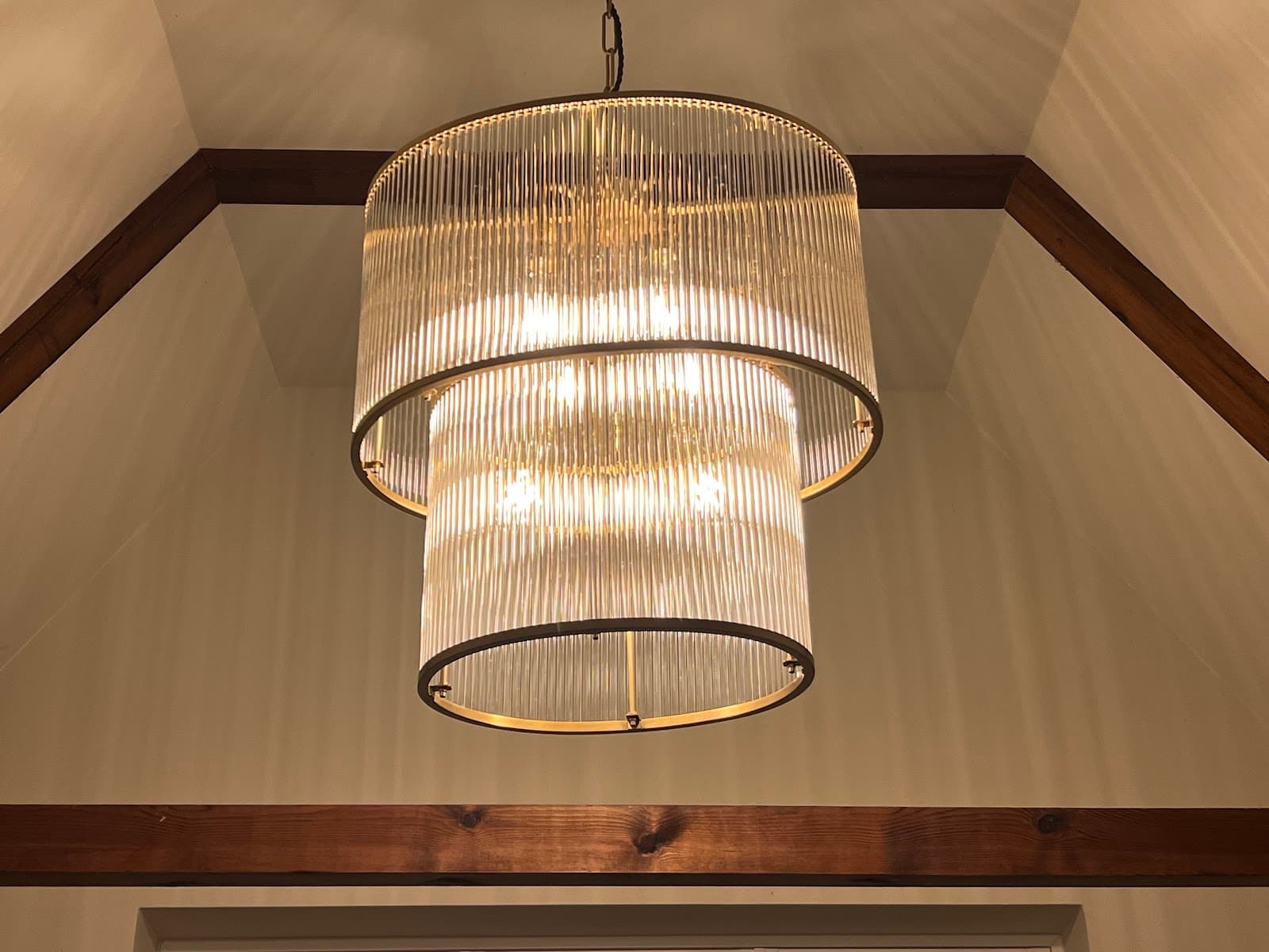 Two-tier glass-rod chandelier fitted in a vaulted ceiling
