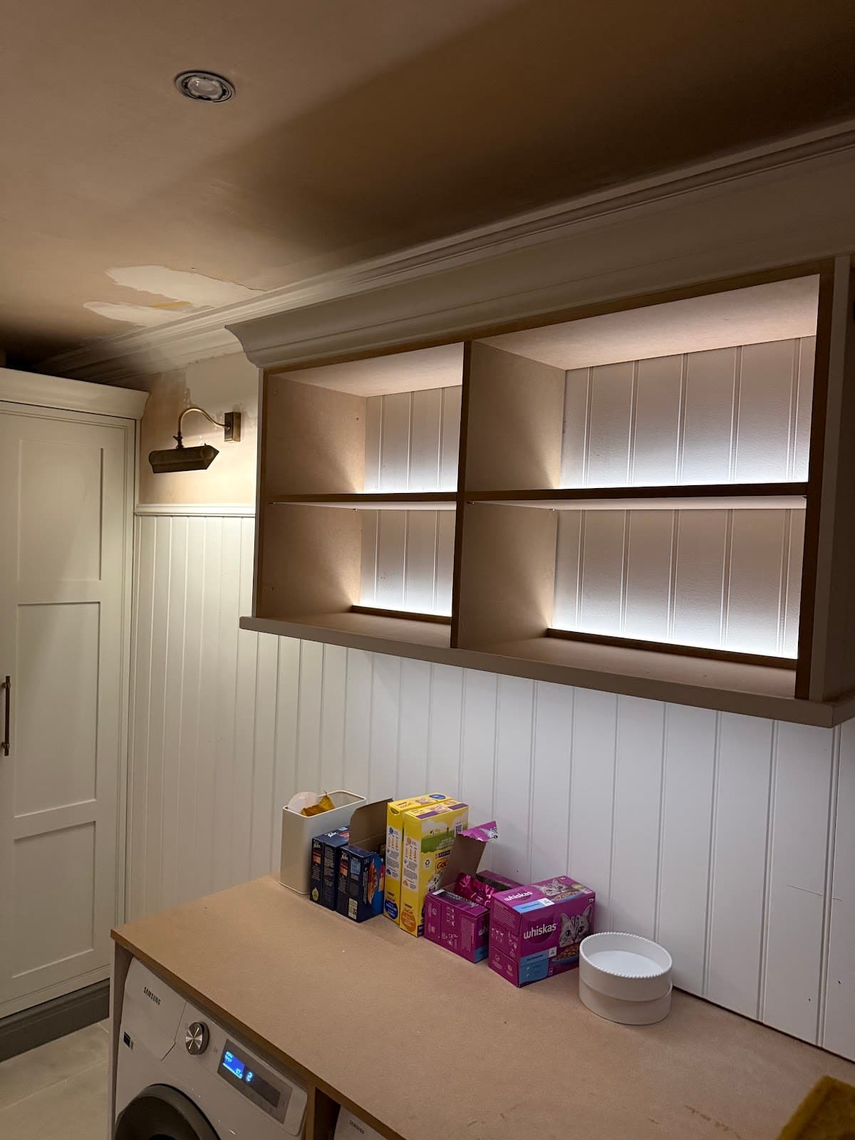 LED strip lighting fitted to utility room shelving